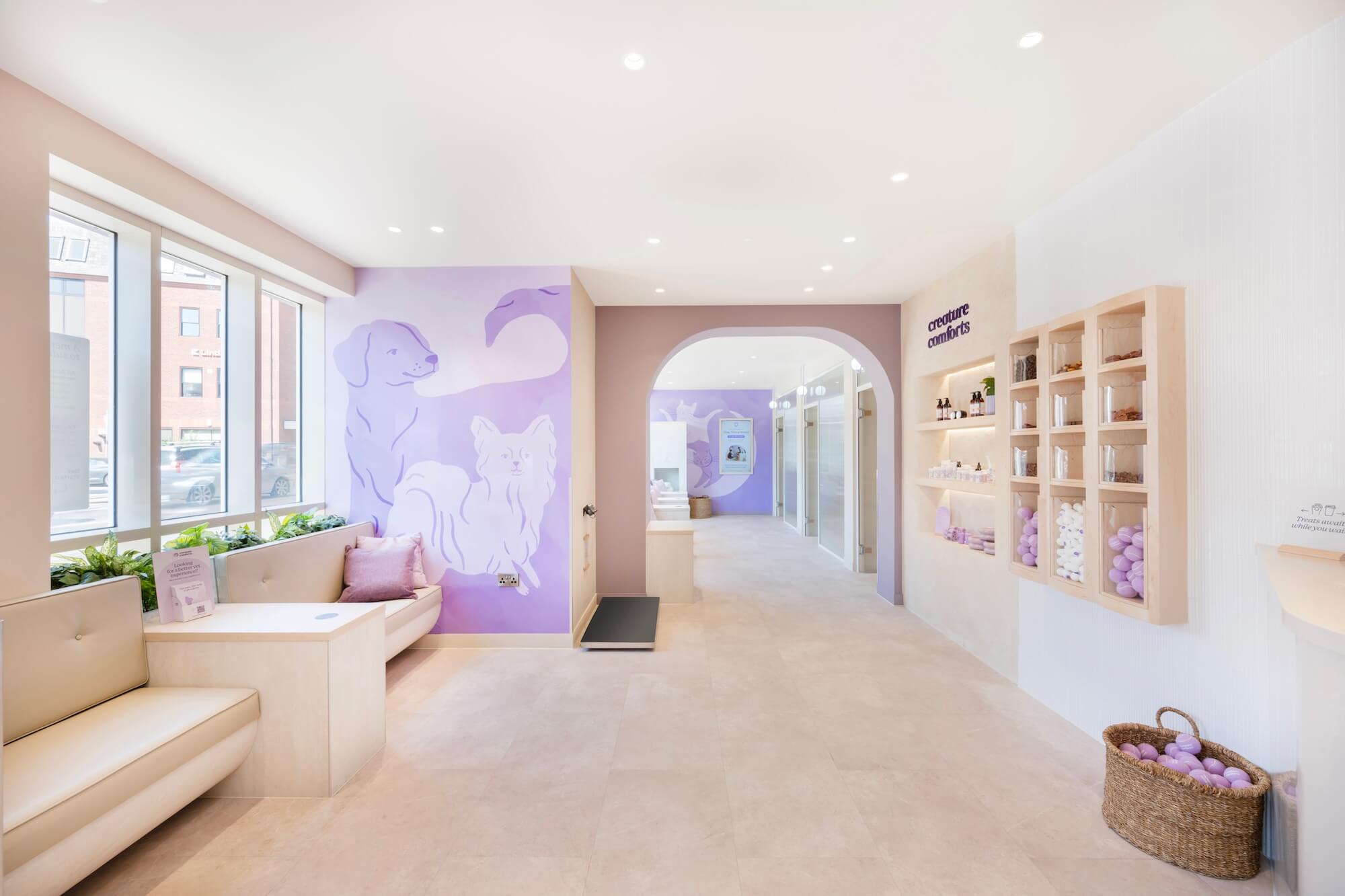 Bright, modern and welcoming interior of a Creature Comforts clinic with light beige seating and lavender decor.