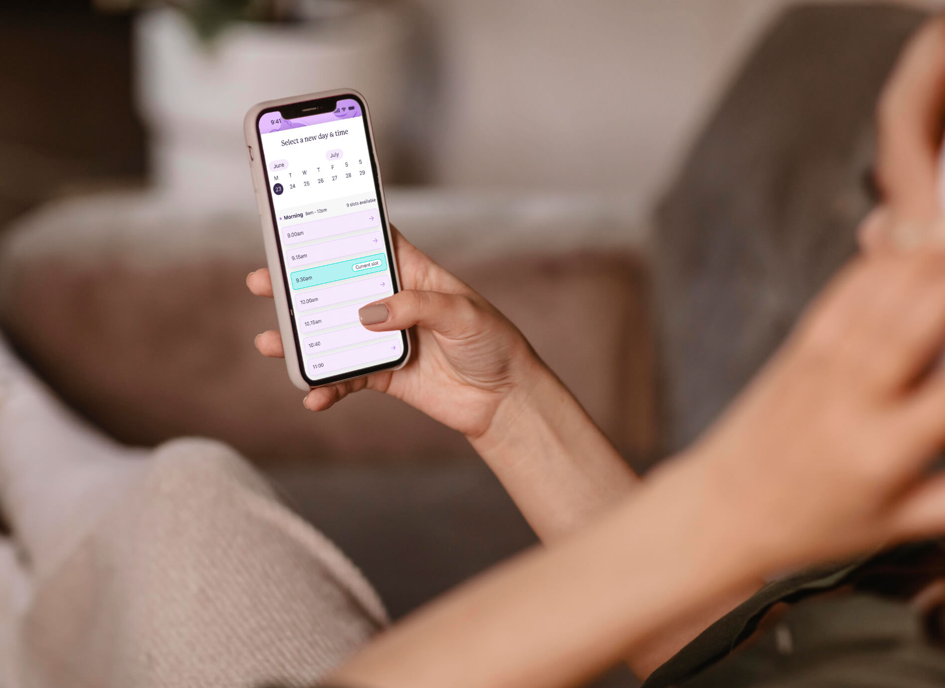 A person holding a smartphone displaying the creature comforts app.